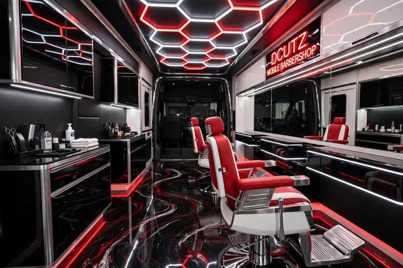 Inside the DCUTZ mobile barbershop van with red leather barber chairs, hexagon ceiling lights and a glossy black and red floor